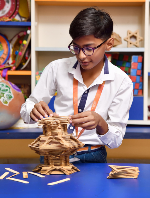 Middle wing student building a model at Jaipuria Bhiwadi